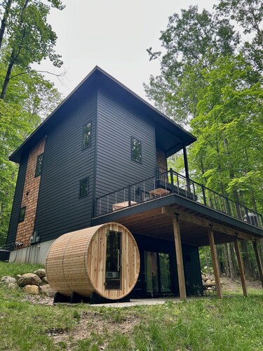 The Holiday House | Modern Wooded Retreat Near TC & Trails | Sauna