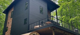 The Holiday House | Modern Wooded Retreat Near TC & Trails | Sauna