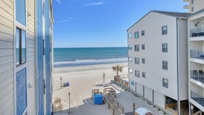 A beachfront hotel with a view of the ocean, a sandy beach, and a palm tree. - Seasider 304 - Three Bedrooms, Three Bath Condo in Oceanfront Complex (Garden City Beach)