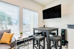 Relax in this stylish room with a large window, flat-screen TV, and comfortable sofa.