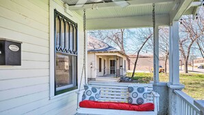 A porch with a swing seat, a mailbox, and a house in the background. - Georgetown Vacation Rental Close to Town Square! (Georgetown)