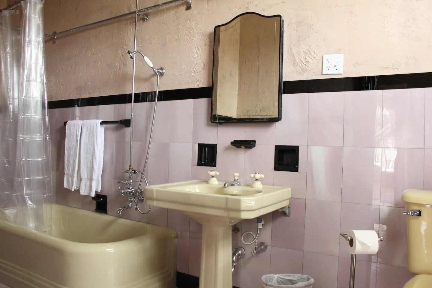 A bathroom with a bathtub, a sink, a toilet, and a shower.