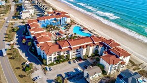 A resort with multiple buildings, a swimming pool, and a beach. - Beachfront Capriani Resort, Private Balcony, Ocean Pool Views, Linens Towels (North Topsail Beach)