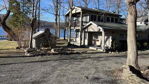 A two-story house with a balcony, a small cabin, and a dock by a lake. - Moonlight Manor on Keuka Lake in Hammondsport (Hammondsport)