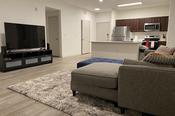 Comfy spacious living room with 65 inch smart TV