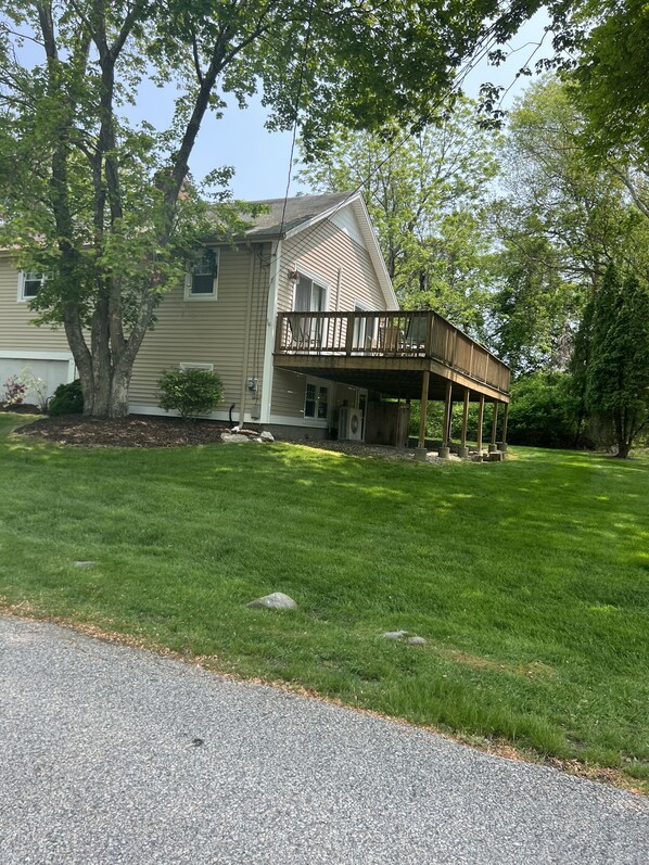 A house with a covered porch and a lawn.