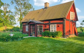 Traditional home with a charming porch and beautifully manicured lawn.