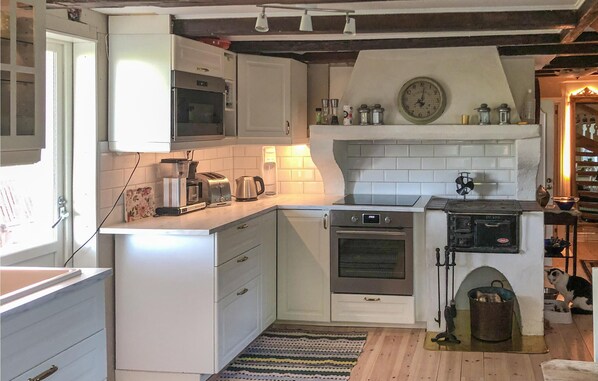 Enjoy cooking in this well-lit kitchen with an oven and modern cabinetry.