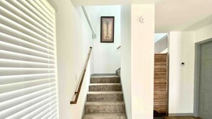 A staircase with carpeted steps leading to a wooden door. - No Minimum Stay! No Chores! Kids allowed (Port O'Connor)