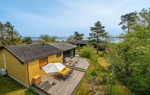 A single-story building with a patio area, a small deck, and a view of the sea. - Cozy home in Nexø with house sea view (Nexø)
