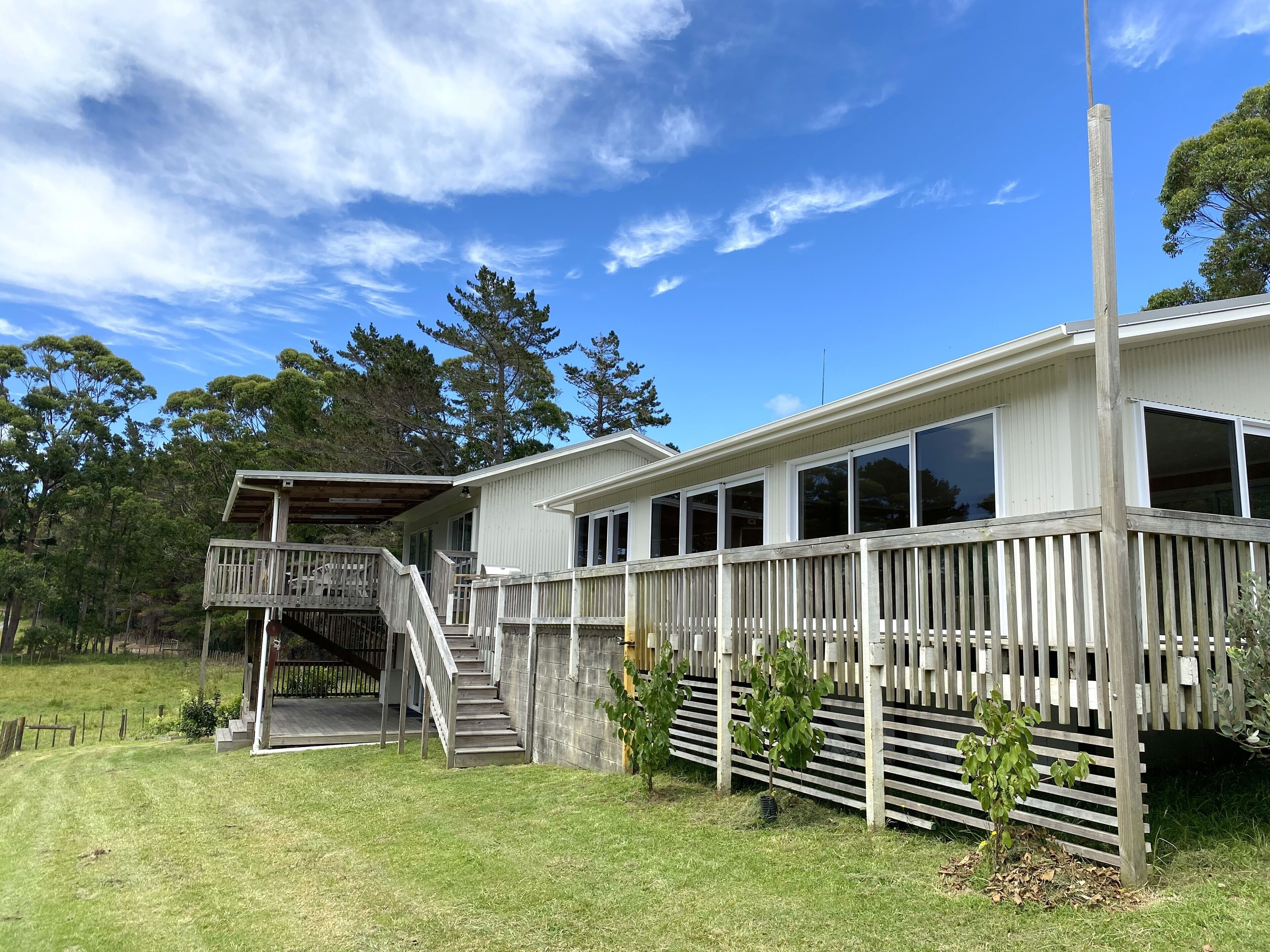 A two-story house with a balcony and a covered porch.