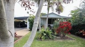 A house with a front yard, a garage, and a covered porch.