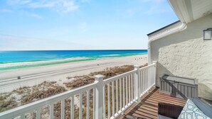 Ein Balkon mit Blick auf Strand und Meer.