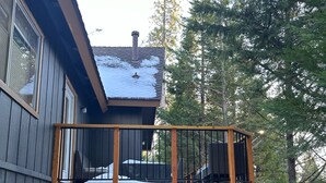 A two-story house with a balcony and a deck.