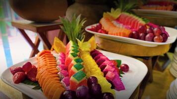 A variety of sliced fruits arranged on plates, including watermelon, pineapple, and dragon fruit.