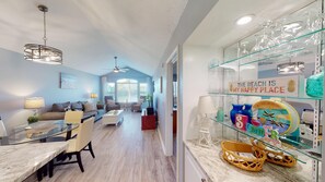 Relax in a stylish living area with a sofa, chairs, dining table, and kitchenette.
