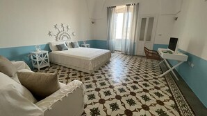 A bedroom with a bed, a desk, a chair, and a small table. - Finished house, 100sqm 10 min from the beaches, 500 m from the historic center of Ugento (Ugento)