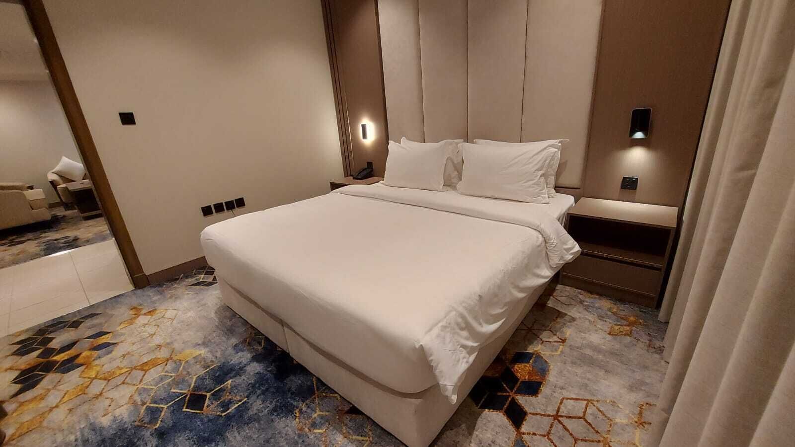 Desk, laptop workspace, iron/ironing board, bed sheets