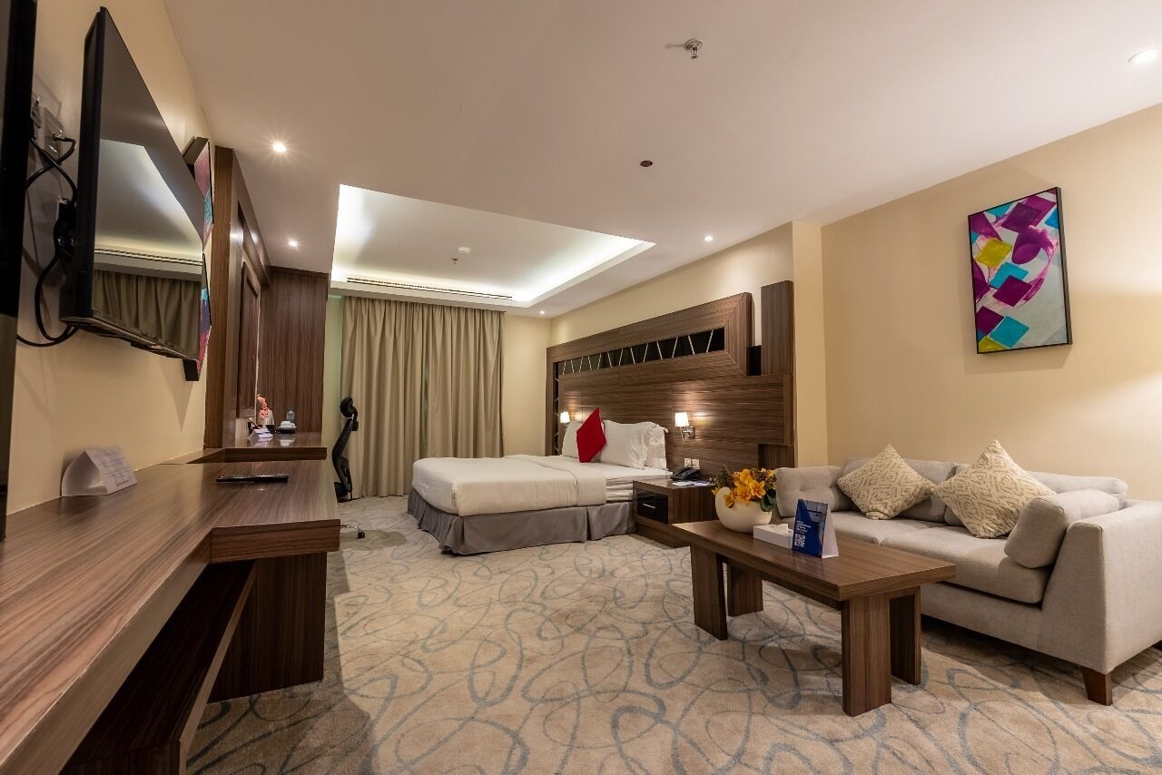 Desk, laptop workspace, iron/ironing board, bed sheets