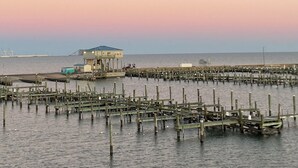A waterfront pier with a building, wooden structures, and calm water. - Coastal home walking distance to the beach (Long Beach)