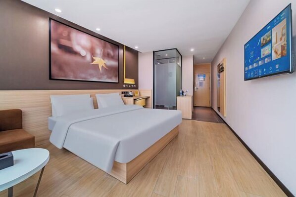 A modern hotel room with a large bed, a desk, a chair, and a TV mounted on the wall. - IU Hotel (Chongqing Hechuan Ruishan Road Ta'ermen Square) (Chongqing)