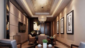 A modern hotel lobby with a dining area, framed artwork, and a chandelier. - Bojing Hotel (Yuechi)