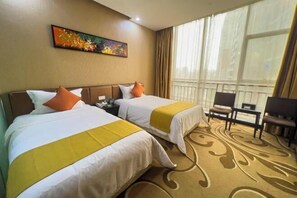 A hotel room with two beds, a large window with curtains, a painting on the wall, and a chair by the window.