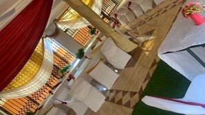 A spacious hall with tiered seating and draped curtains. - SWATSON HOTEL (Kumasi)