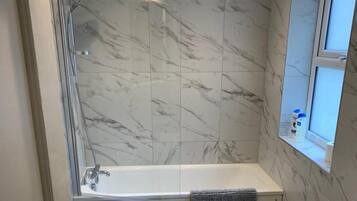 Combined shower/bathtub, deep-soaking bathtub, hair dryer, towels
