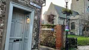 A stone building with a sign reading "The Bayle" and a lamp post. - The Turret - The Best View in Folkestone (Folkestone)