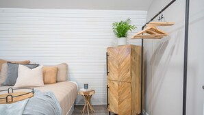 A bedroom with a bed, bedside table, and a wardrobe. - Beautiful newly renovated home w/ canal view (Port Colborne)