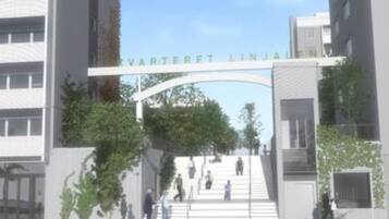 A modern building entrance with a sign above the door.