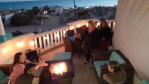 A terrace with outdoor seating and a fire feature, overlooking a beach and ocean. - #4, VRBO MAP PLACEMENT WRONG, CHECK GOOGLE MAP,LAS CONCHAS,1ST HOUSE, HEART ICON (Puerto Peñasco)