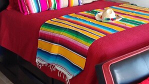A bed with colorful striped bedding, a star-shaped hanging light, and a small nightstand with a lamp. - #4, VRBO MAP PLACEMENT WRONG, CHECK GOOGLE MAP,LAS CONCHAS,1ST HOUSE, HEART ICON (Puerto Peñasco)