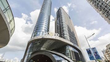 A modern building with a curved facade and two prominent towers.