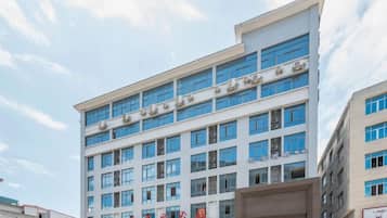 A multi-story building with a flat facade, numerous windows, and a visible entrance.