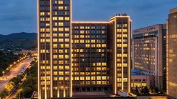 A multi-story hotel with a prominent entrance and a large sign.