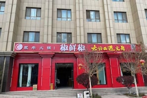 Un edificio con fachada roja y varias ventanas.