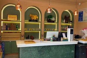 Un espace bar comprenant un comptoir, des étagères remplies de bouteilles et des éléments décoratifs.