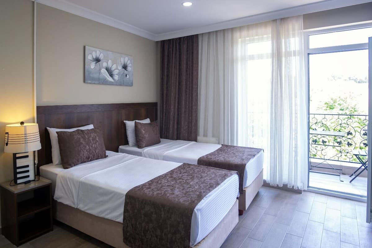 Twin Room, Balcony | Free minibar items, in-room safe, desk, laptop workspace