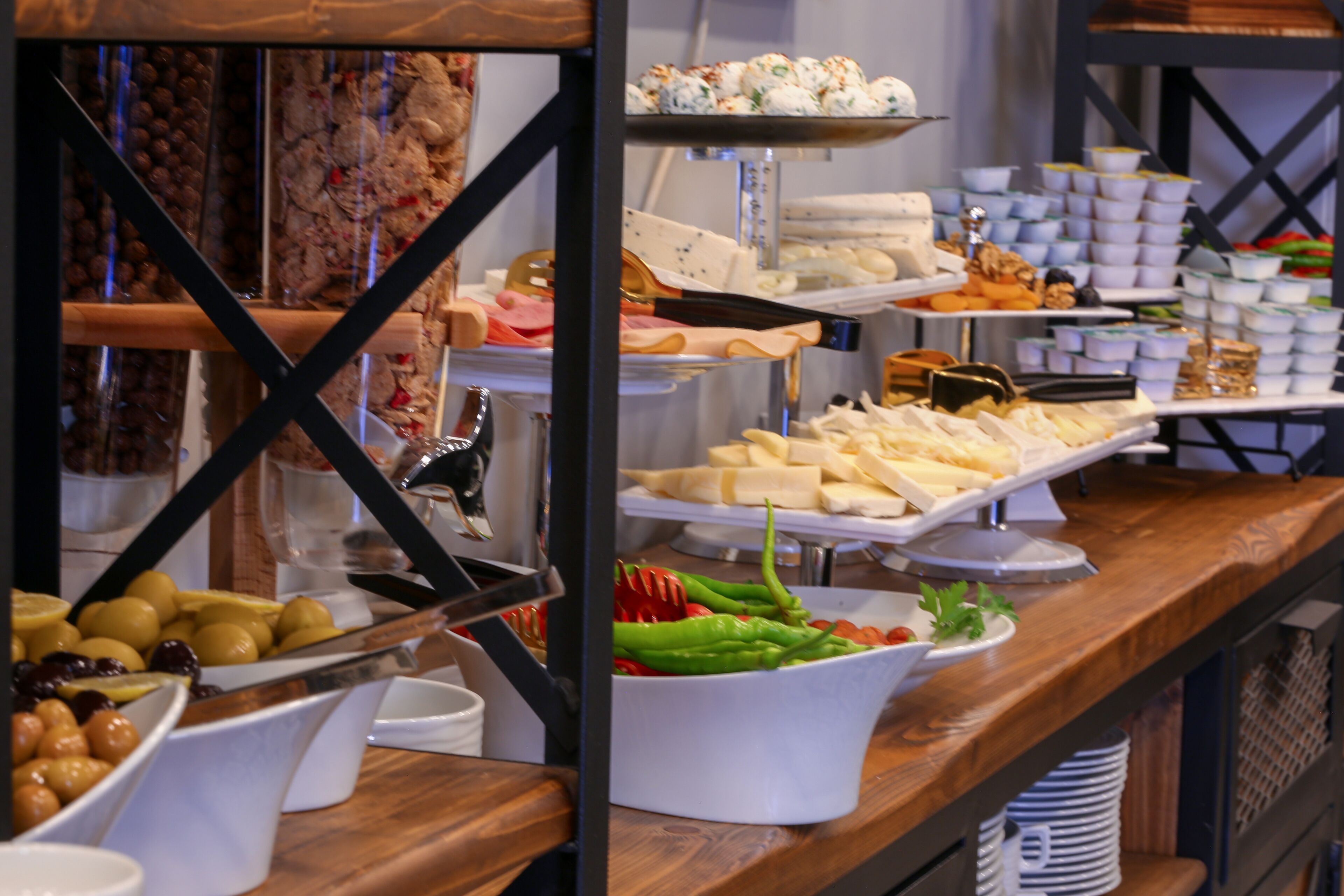 A buffet with various food items including fruits, cheeses, and vegetables.