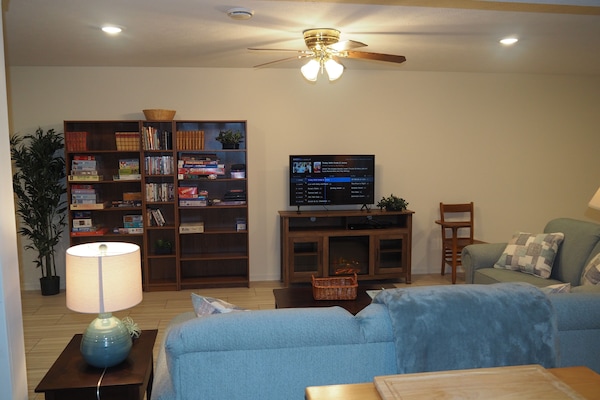 LIVING ROOM: The apartment has a very comfortable living room with a sleeper sofa, comfy chair, ceiling fan, table, and television.