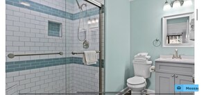 A bathroom with a glass shower enclosure, a white toilet, and a vanity with a mirror. - Amazing Ocean and Pool Views!  Unit 211 - BEAUTIFUL POOL DECK REMODEL COMPLETE! (North Myrtle Beach)