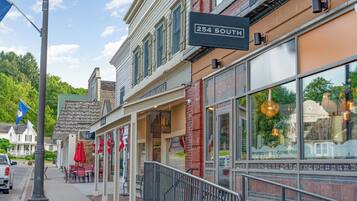 A street view with a building labeled "254 SOUTH" featuring a storefront with large windows and outdoor seating.