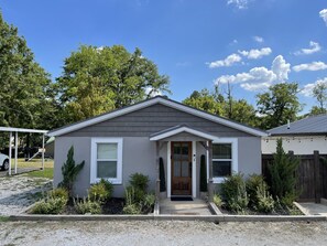Stroll up to this charming single-story home with a cozy front porch and beautifully manicured grounds.