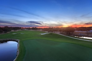 A golf course with a pond, sand bunkers, and trees. - Private River Access, Pool, Hot tub, BBQ grill walk downtown & Bahn. Free Tubes! (New Braunfels)