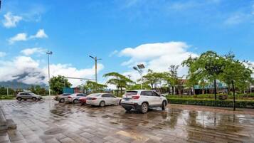 A parking lot with multiple cars and a clear sky.