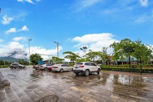 A parking lot with multiple cars and a clear sky.