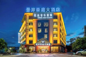 A multi-story hotel building with a prominent entrance and signage.