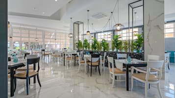 A modern dining area with marble flooring, multiple dining tables, and chairs.